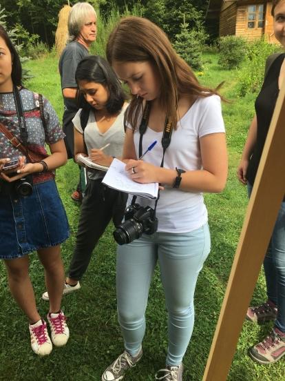 High School volunteers listen intently as part of their Journalism Project in Romania Teenage volunteer takes note during an interview on her Journalism Project in Romania